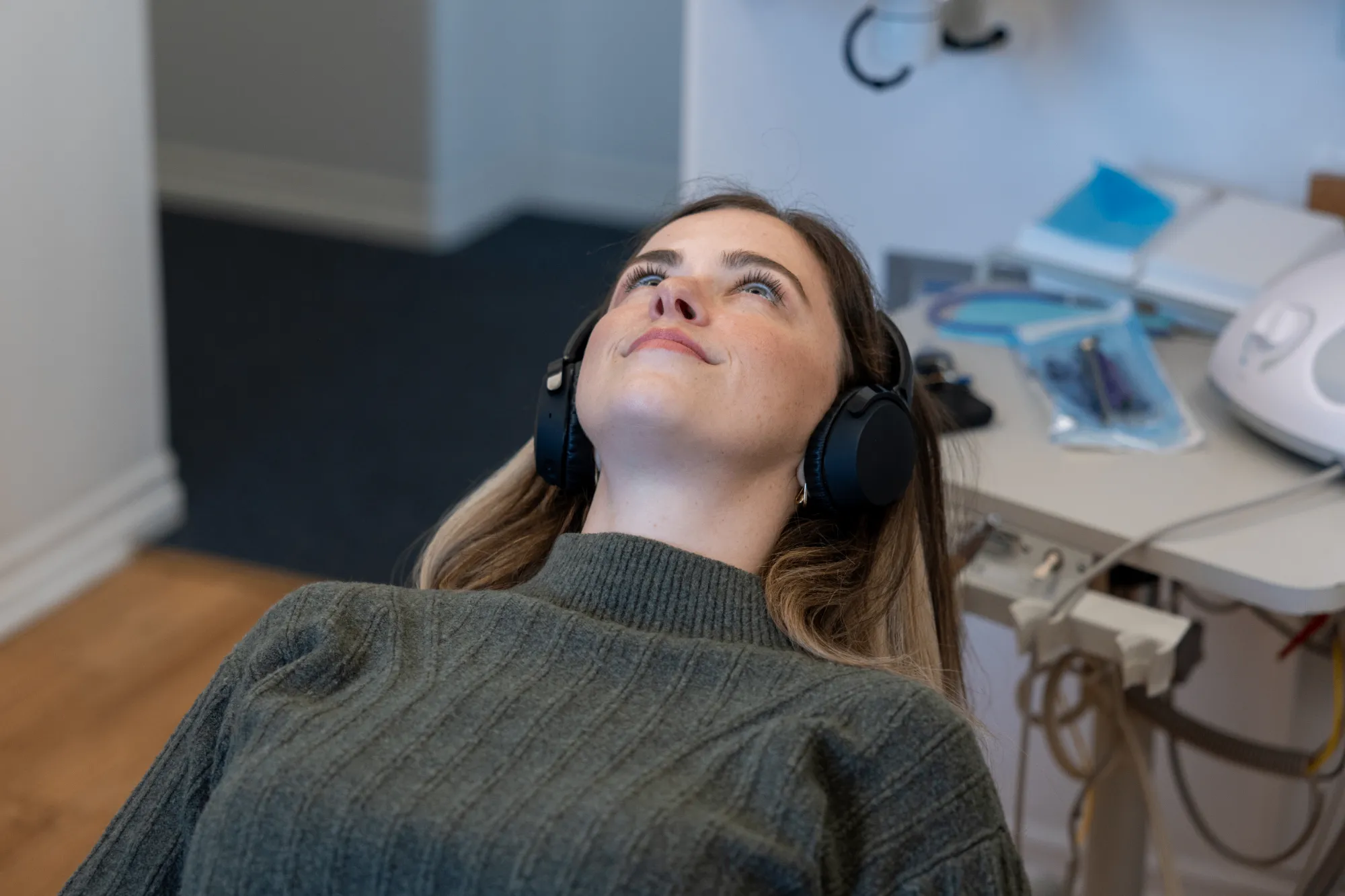 patient relaxing in a dental chair with headphones during a sedation dentistry visit in University Heights