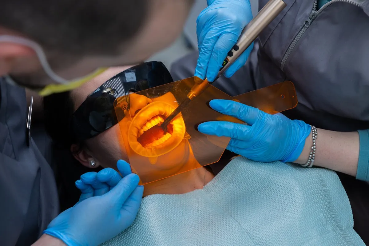 Man pointing at bright smile - Sunrise Dental Arts Care Treating gum disease