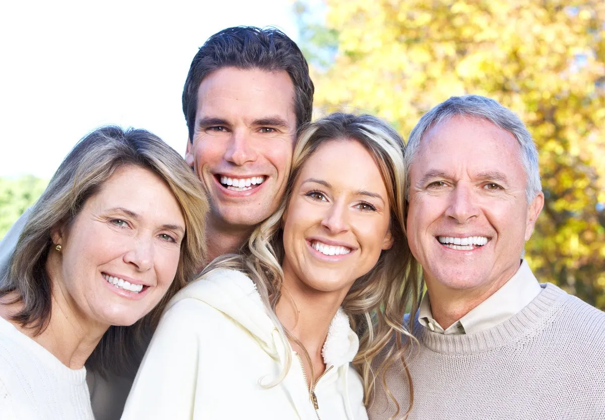 Man pointing at bright smile - Sunrise Dental Arts Care Smiling family picture