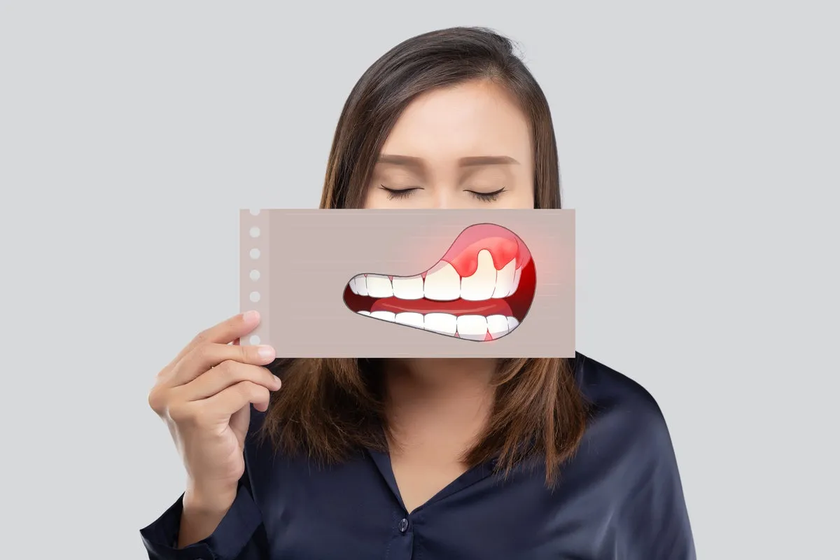 Couple smiling while looking at phone - Sunrise Dental Arts Care Woman showing what a gum disease is like