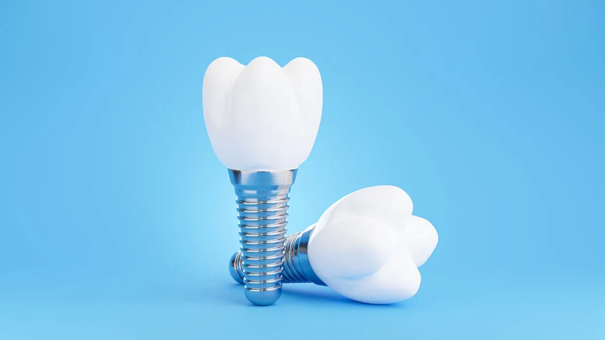 Couple smiling while looking at phone - Sunrise Dental Arts Care Implant crowns