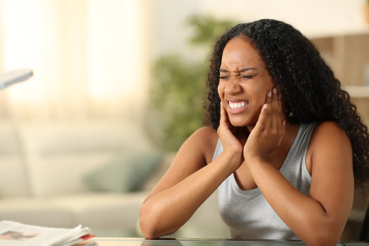 Happy couple smiling outdoors - Sunrise Dental Arts Care Woman experiencing jaw pain