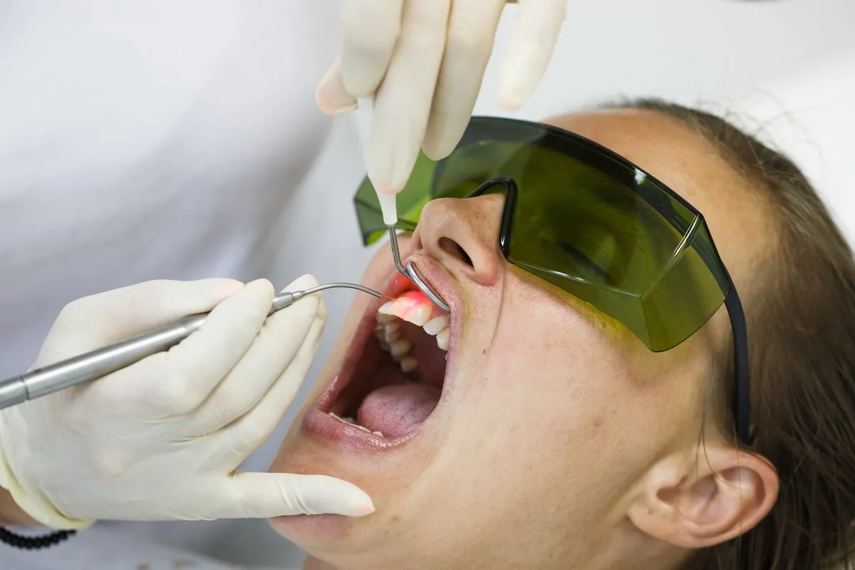 Happy couple smiling outdoors - Sunrise Dental Arts Care Woman having a gum disease treatment