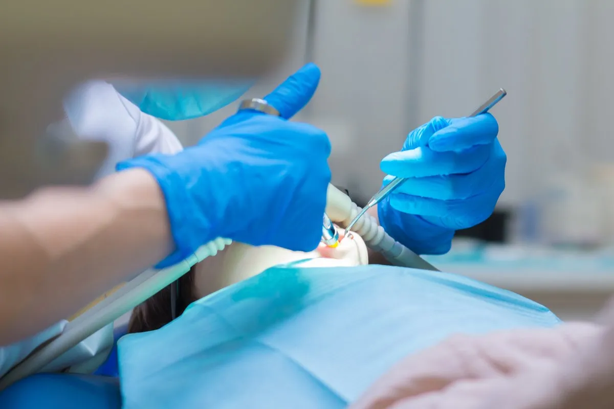 Couple smiling while looking at phone - Sunrise Dental Arts Care Dentistry. Dental treatment in the clinic under sedation.