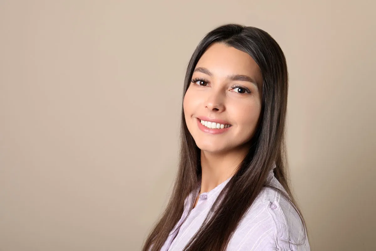 Happy couple smiling outdoors - Sunrise Dental Arts Care Young woman with healthy teeth on color background.