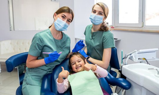 Child smiling during a pediatric dental sealant checkup
