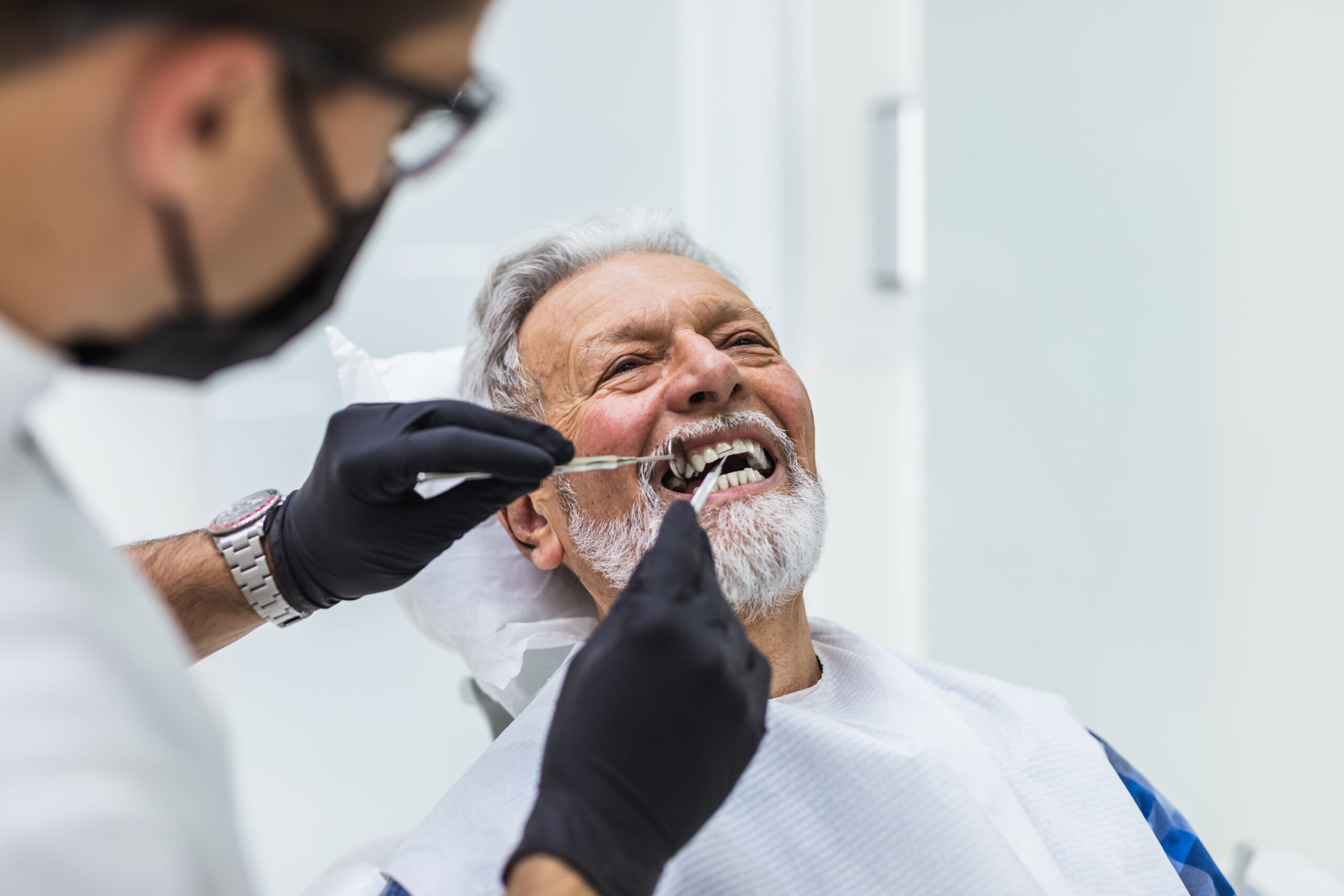 Couple smiling while looking at phone - Sunrise Dental Arts Care